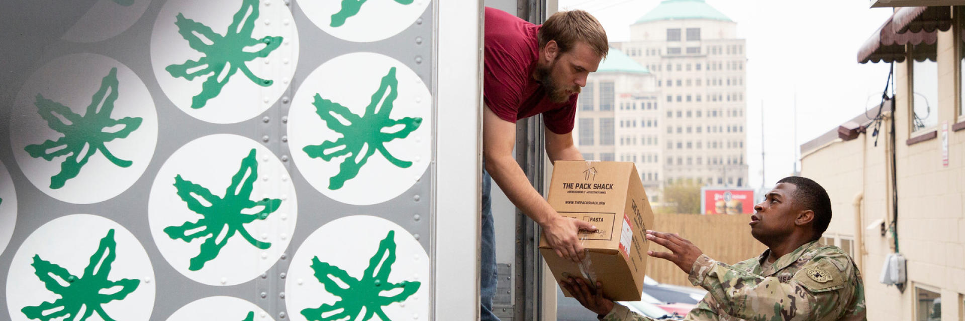 Two men unloading the Ohio State Buckeyes truck during the Pack Shack meal delivery