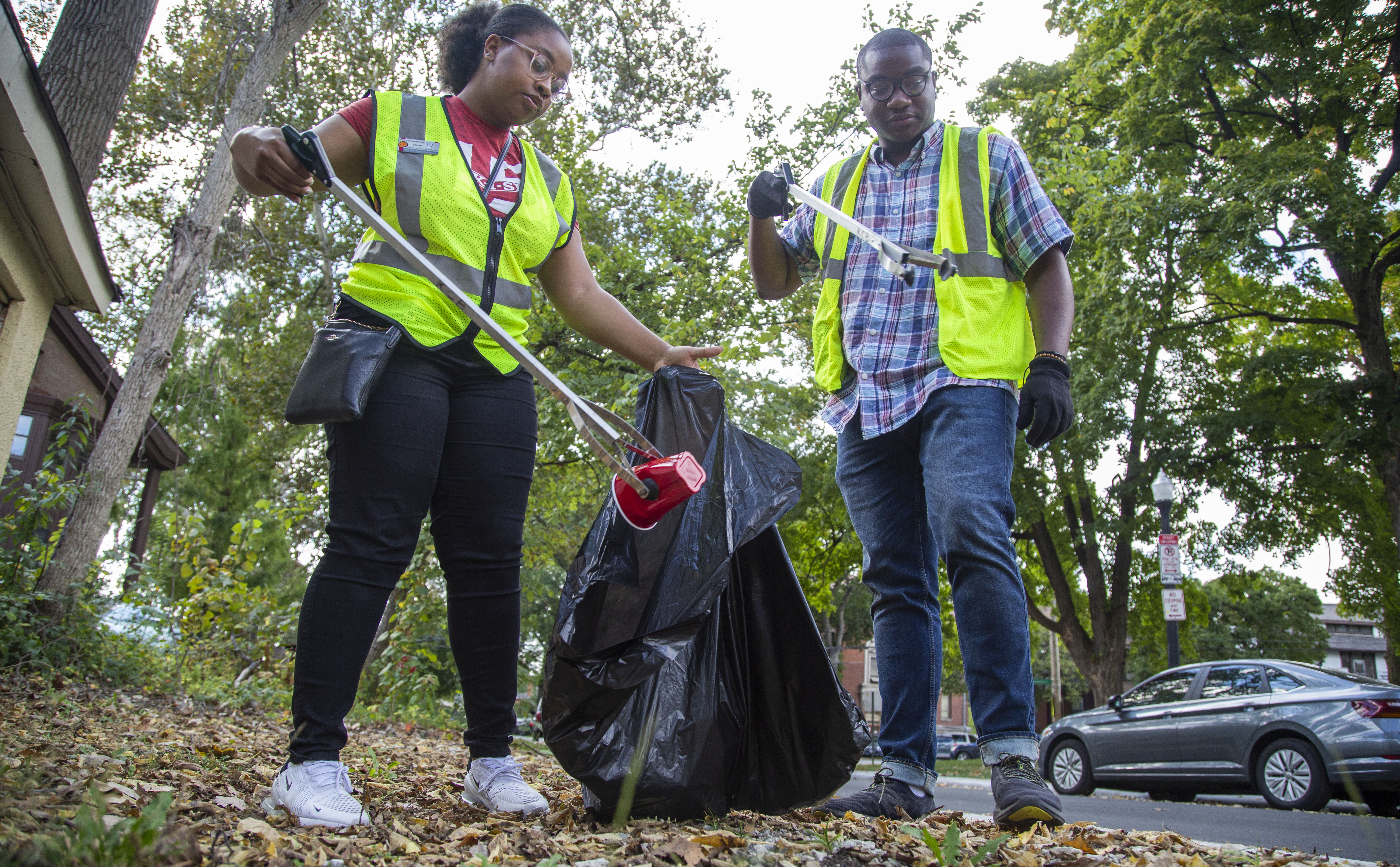 Two students participating in the University District Clean Up